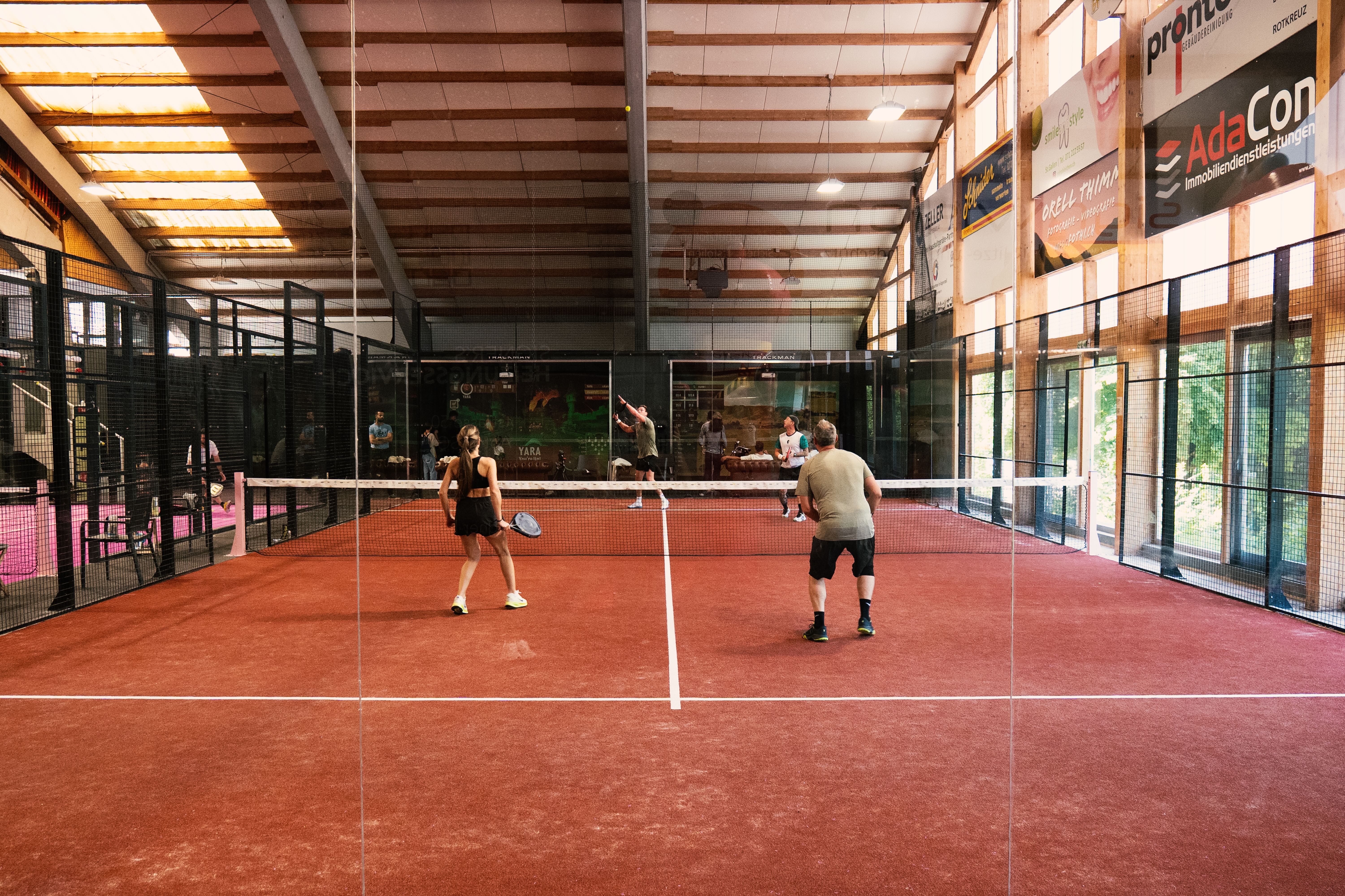 cinematic low angle shot of a modern blue padel court with bright stadium lights at night
